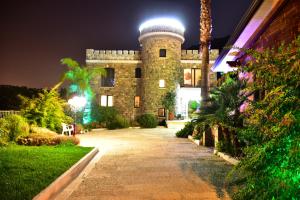 a building with a tower on top of it at night at Villa Le Favole in Sant'Egidio del Monte Albino