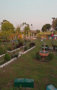 a park with a fountain in the middle of a field at Ecopark Homestay in Bharatpur