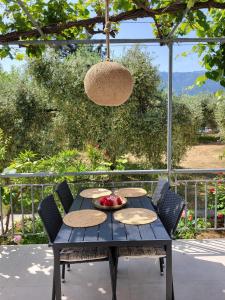 a blue table with a bowl of fruit on it at Ferienhaus In Thasos Mit Großer Terrasse in Potamia