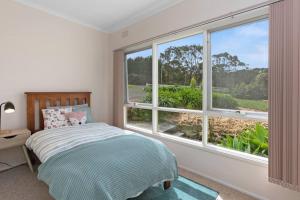 En eller flere senge i et værelse på The Great Ocean Villa