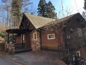 a small house with a large driveway in front of it at Cottage 62 Seseraginomori Kyu-karuizawa in Karuizawa