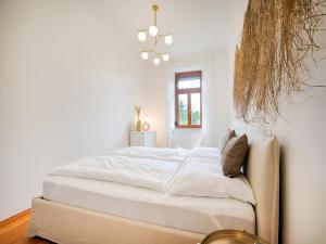 a bedroom with a bed with white sheets and a window at Family-Friendly Apartment in Graz in Graz Ostbahnhof