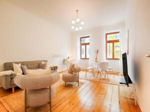 a living room with a couch and chairs and a table at Family-Friendly Apartment in Graz in Graz Ostbahnhof