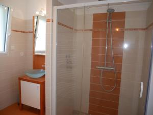 a bathroom with a shower with a glass door at Holiday home with partial sea view, Douarnenez in Tréboul +28 photos