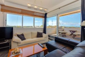 a living room with a couch and a tv at artQhost Costa Ballena Penthouse Ocean and Golf views & Free Parking in Costa Ballena