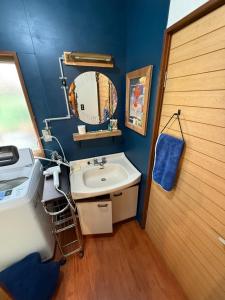 a bathroom with a sink and a mirror at Hakushu hutte in Hokuto +31 photos