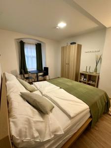 a bedroom with a large bed with a green blanket at RP-Apartments in Graz