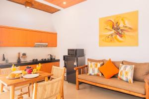 a living room with a couch and a table at Tranquil 2BR Villa, Near Canguu and Pererenan in Tumbak Bayuh