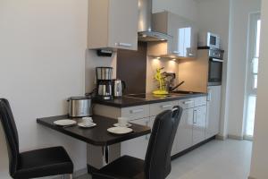 a kitchen with a table and chairs in a room at Ferienwohnung Möwennest in Göhren