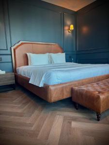 a bedroom with a large bed with blue walls at The Sapphire View Suite in Mexico City +27 photos