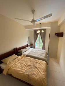 a bedroom with two beds and a ceiling fan at Jo’s Place Cameron Highlands EA922 in Brinchang