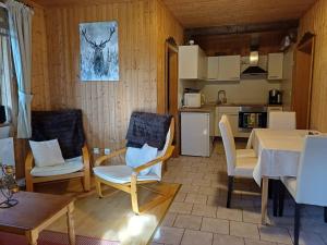 a living room with a table and chairs and a kitchen at Appartement Murtalblick In Pöls in Pöls