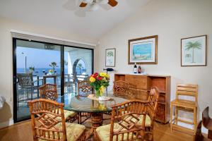 a dining room with a table with a vase of flowers at 152-4 Coastal Luxury with Panoramic Ocean View in Oceanside