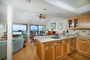 a kitchen and living room with a view of the ocean at 152-4 Coastal Luxury with Panoramic Ocean View in Oceanside +23 photos