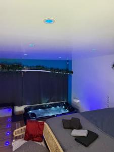 a bedroom with a bed and a bath tub at Love 2 avec Jacuzzi in Cap d'Agde