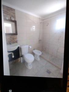 a bathroom with a toilet and a sink at Lajas del Parque in Tandil