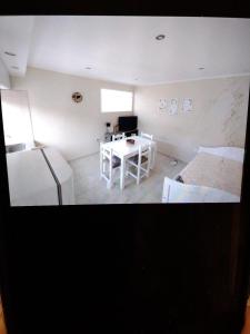 a room with a bed and a desk in it at Lajas del Parque in Tandil