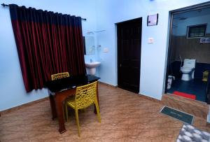 a room with a piano and a bathroom with a toilet at NARMADA POOL VILLA (KAVERI) in Perintalmanna