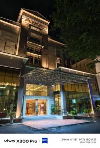 a large building with a lot of windows at night at The Jerai Hotel Sungai Petani in Sungai Petani