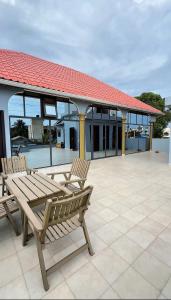 two wooden benches sitting on top of a patio at Paradis Douillet in Cotonou