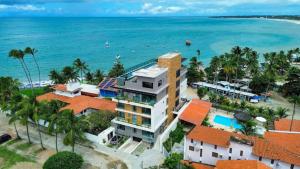 an aerial view of the resort and the ocean at Flat pé na areia na praia de Porto de Galinhas próximo as piscinas naturais. in Porto De Galinhas