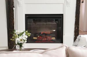 a fireplace in a living room with a fire at Rustic Chic 200 metres from CBD in Bathurst +23 photos
