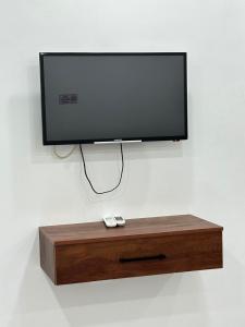 TV de pantalla plana en un soporte de madera con 2 mandos a distancia en Princ pyramids view, en El Cairo 37 fotos más