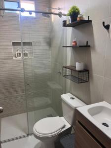 a bathroom with a shower and a toilet and a sink at Holtalia in Santiago