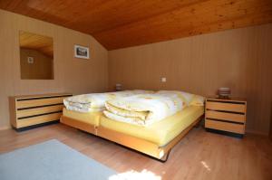 a bedroom with two beds and a wooden ceiling at Ferienwohnung Sutter In Brülisau Bei Appenzell in Rüthi