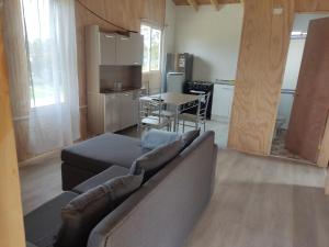 a living room with a couch and a table and a kitchen at Princesa in Puerto Montt +9 photos