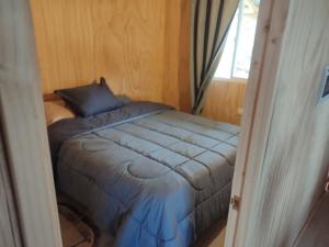 a small bed in a room with a window at Princesa in Puerto Montt