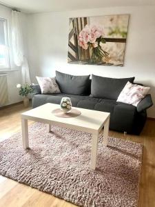 a living room with a couch and a white coffee table at Ferienhaus In Pirna Mit Schöner Terrasse in Pirna