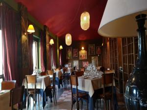 une salle à manger avec tables, chaises et lustres dans l'établissement Apartment in Roma by Marco Simone Golf, à Marco Simone