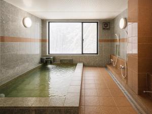 a bathroom with a pool of water with a window at Wonderwall美好境界 日本藏王館 in Yamagata +22 photos