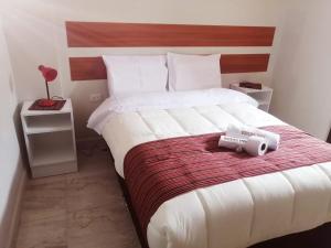 a bedroom with a bed with a speaker on it at Belys inn in Cusco