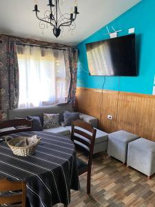 a living room with a table and a couch at Las palmeras de Colbún in Colbún