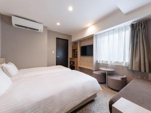 Ένα ή περισσότερα κρεβάτια σε δωμάτιο στο The OneFive Osaka Namba Kuromon +39 φωτογραφίες