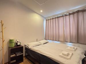 Ένα ή περισσότερα κρεβάτια σε δωμάτιο στο 晴の浜