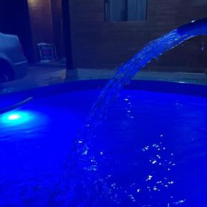 a pool of blue water is being poured at Pousada vô ze in Imbituba