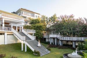 a woman walking down the stairs of a building at Vivace Khaoyai in Mu Si