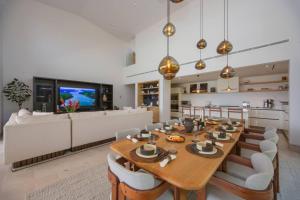 a large dining room with a table and a couch at 4 Bed - Luxury Oceanview Villa in Punta Mita