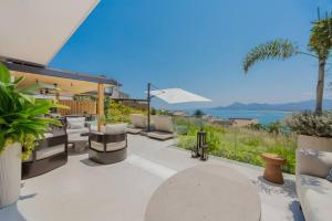 a patio with chairs and a view of the ocean at 4 Bed - Luxury Oceanview Villa in Punta Mita +34 photos