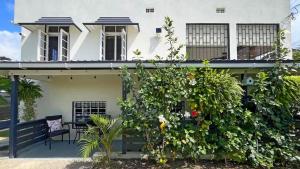 ein weißes Haus mit vielen Pflanzen in der Unterkunft 2 Bedroom - 1 Bath Condo - 2 min walk to beach in Bridgetown