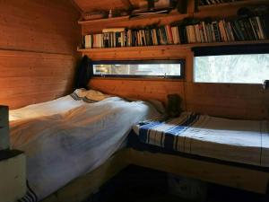 a bedroom with a bed in a log cabin at Ål Cabin With Panoramic Views in Favang