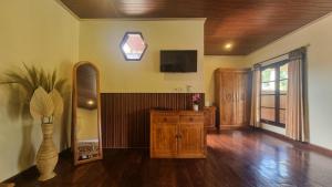 a living room with a tv and a vase at Ananda B&B in Gili Air