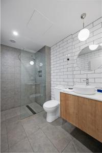 a bathroom with a toilet and a sink and a shower at MJ McMahon Motel in Wonthaggi