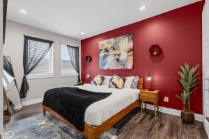 a bedroom with a red accent wall and a bed at JoyFull 2BD In the Heart of Magnolia in Fort Worth