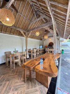 a large wooden table in a room with tables and chairs at Brady's Ubud Villas in Ubud