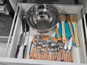 un tiroir rempli d'ustensiles et un bol dans l'établissement Brand New Peaceful and Cozy Suite, à Regina