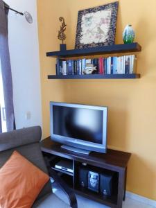 a living room with a flat screen tv on a table at Liebevoll Eingerichtetes Apartment Calima Amarilo in La Pared